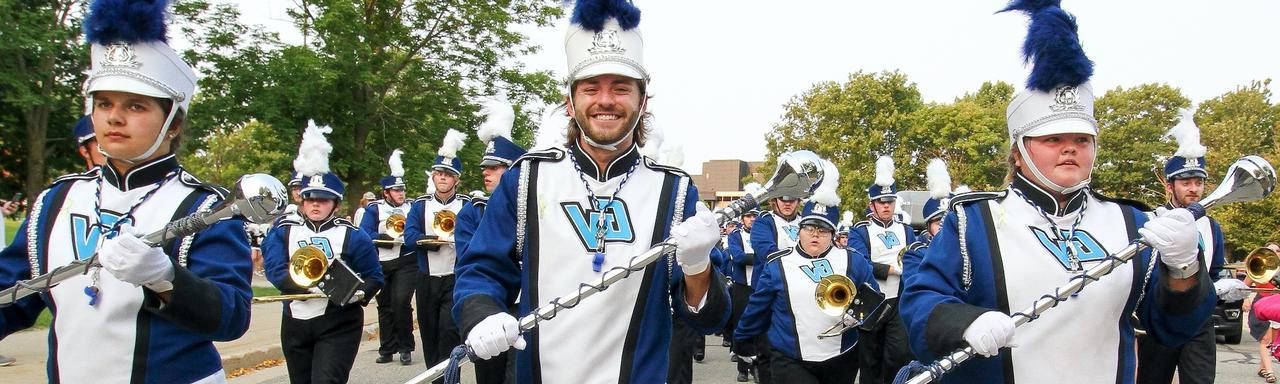 The three drum majors leading the Laker Marching Band as they parade to the Lubbers Stadium